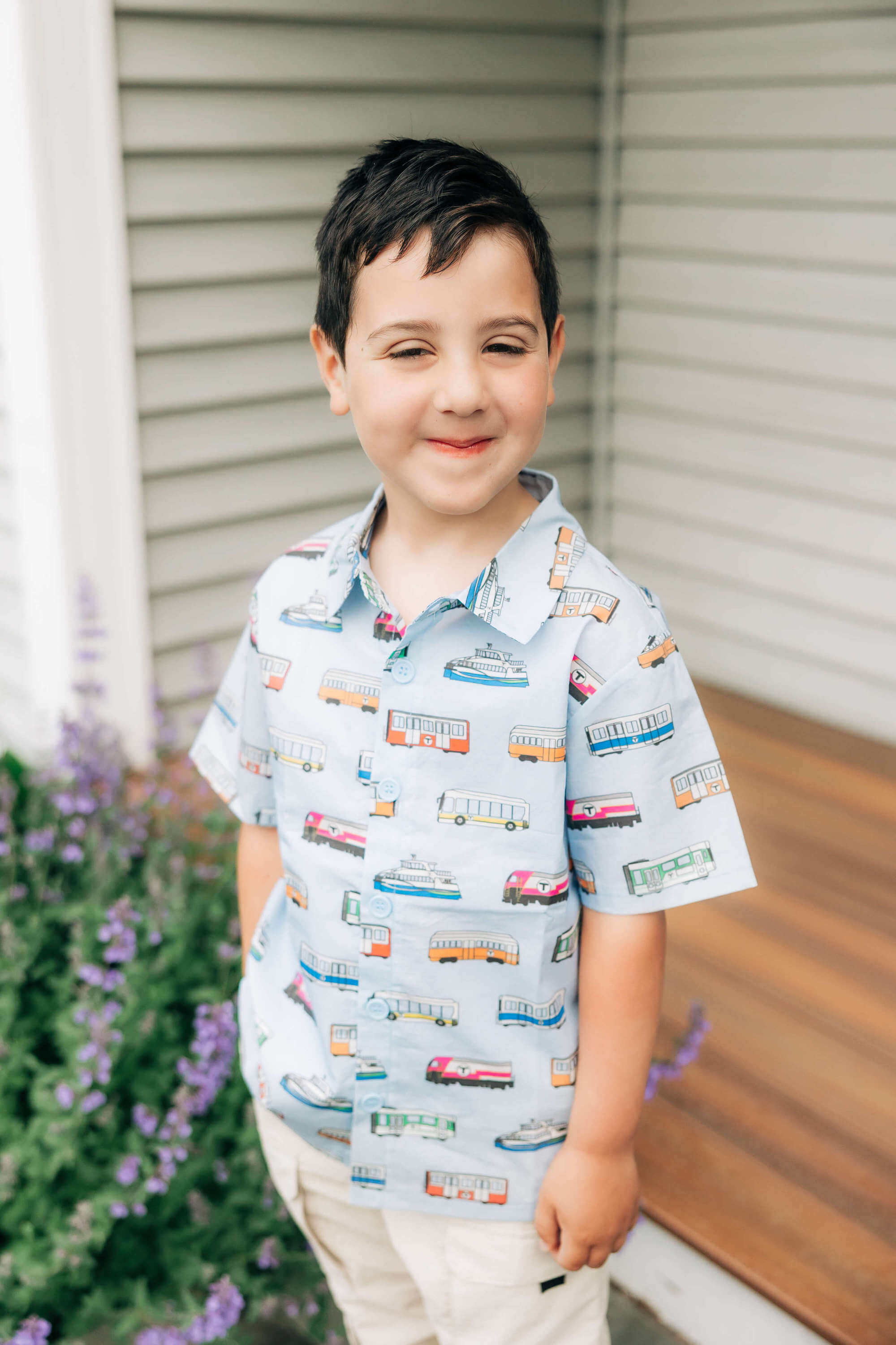 Toddler boy wearing light blue button-up shirt with Boston MBTA vehicles print
